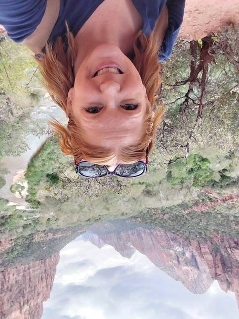       Person taking a selfie in a canyon landscape.
  
