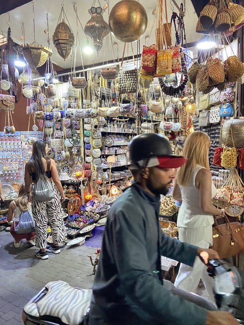 Bustling market with various goods on display.
