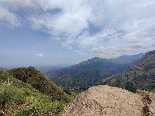 Mountainous landscape with a cloudy sky.