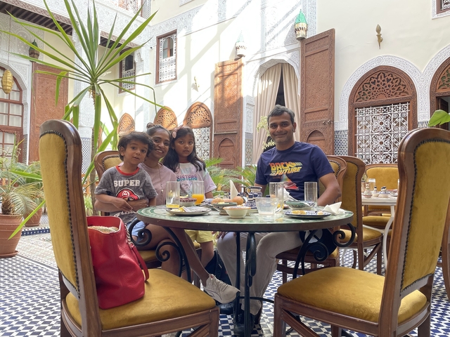 Family dining together in an ornate restaurant.