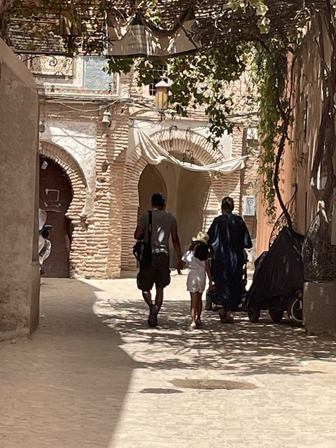 A family walking through an ancient alleyway.