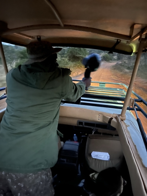       Person in a vehicle on an unpaved road.
  
