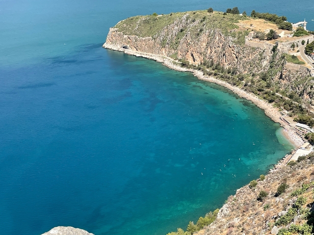       Breathtaking aerial view of a turquoise bay with a rocky coastline.
  