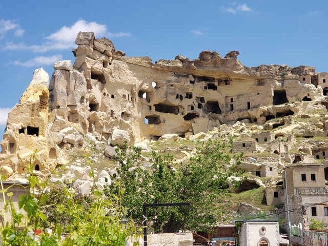       Rocky cliffs with ancient rock-cut dwellings.
  