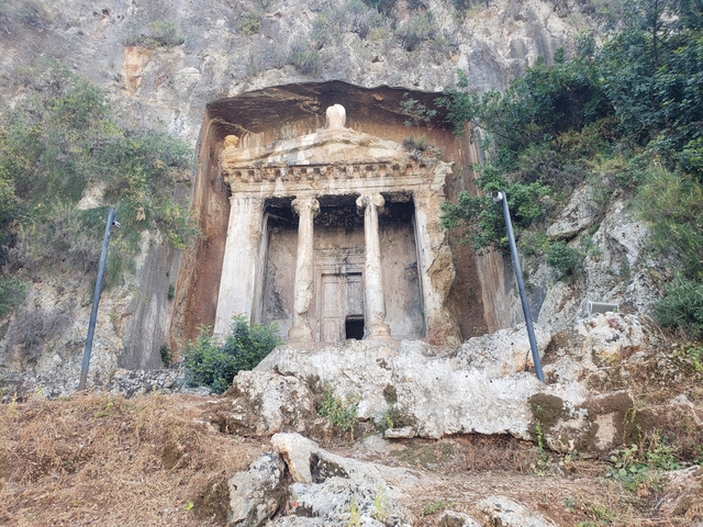       Ancient temple facade carved into a rock wall.
  