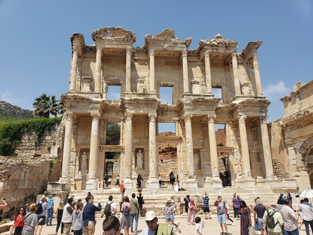       The ancient Library of Celsus ruins with tourists.
  