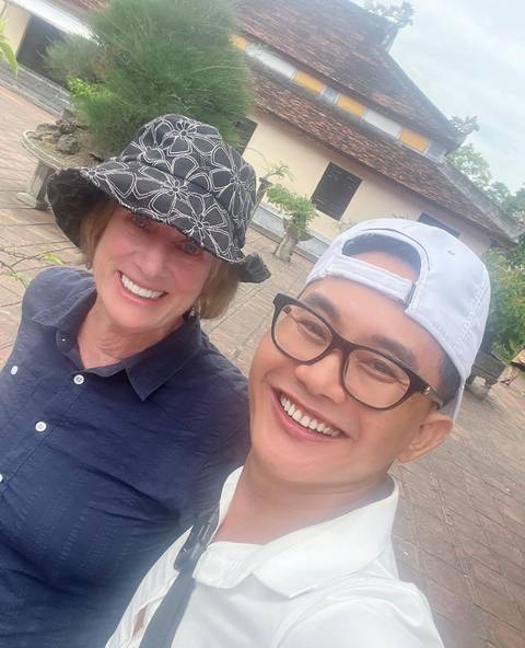 Two people taking a selfie, smiling at the camera.