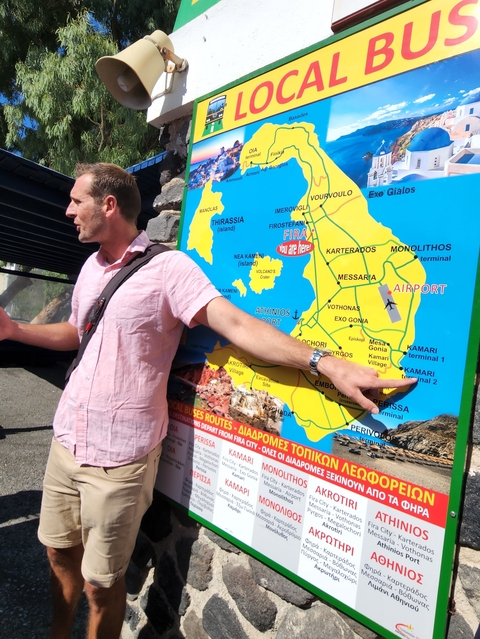       Man pointing at a map of an island.
  