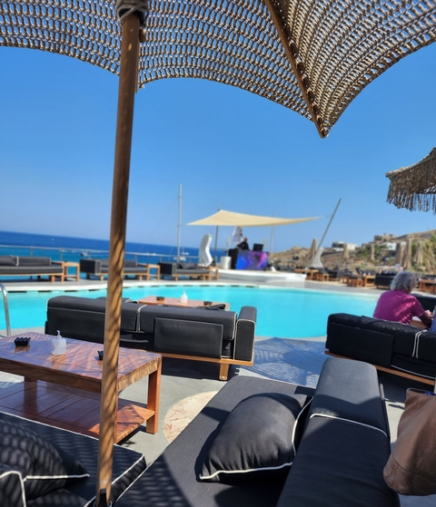       Poolside area with ocean view and lounge chairs.
  