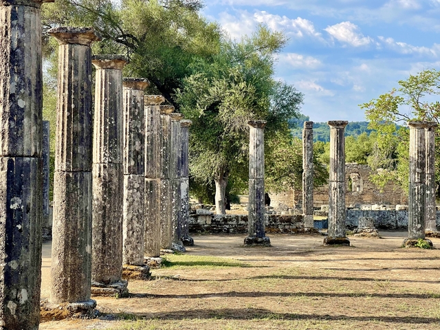 Historic stone pillars in an ancient site with few tourists.