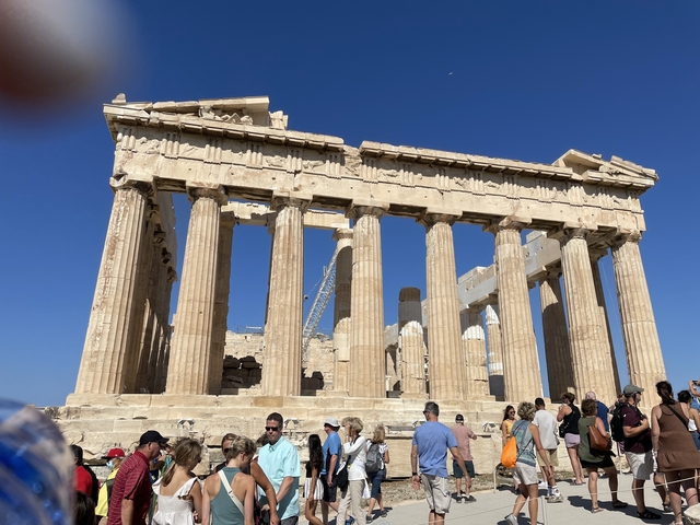       Tourists exploring the Parthenon in Athens.
  