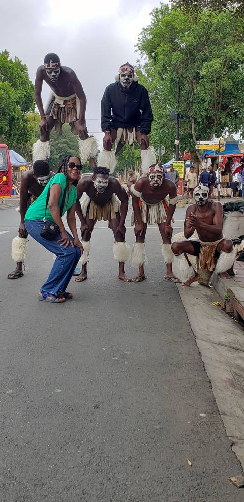 Group of performers in costumes on a street.