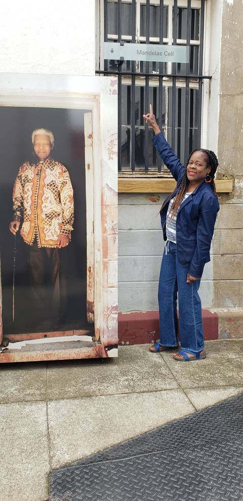 Person pointing at a historical photo display.