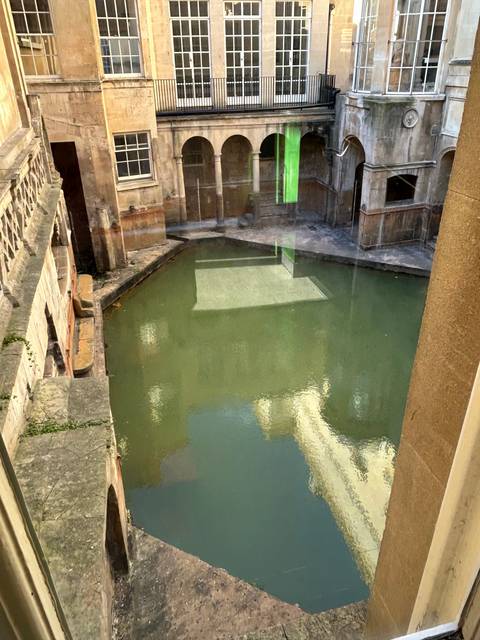       Ancient Roman Baths with reflective water.
  