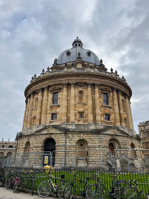       Historic domed building with bicycles parked outside.
  
