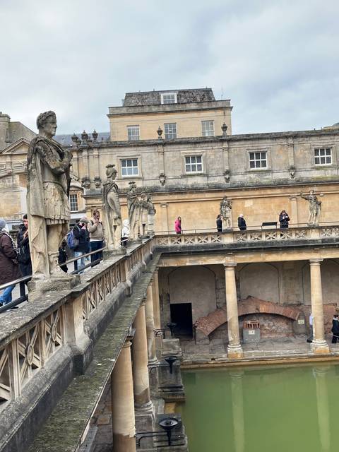       Tourist site with a rectangular pool surrounded by Roman architecture.
  