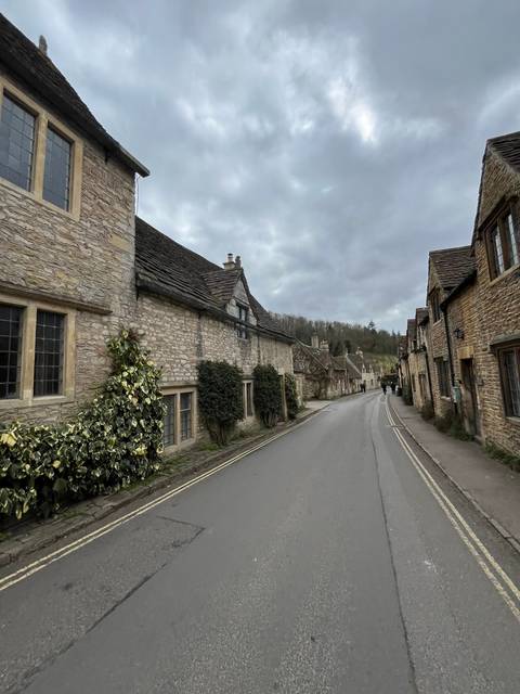       Rural street lined with traditional stone houses.
  