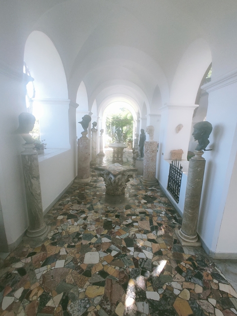       Statues and columns in a hallway
  