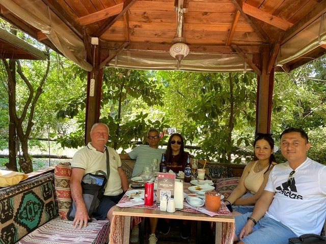      Group of people enjoying a meal in a gazebo
  
