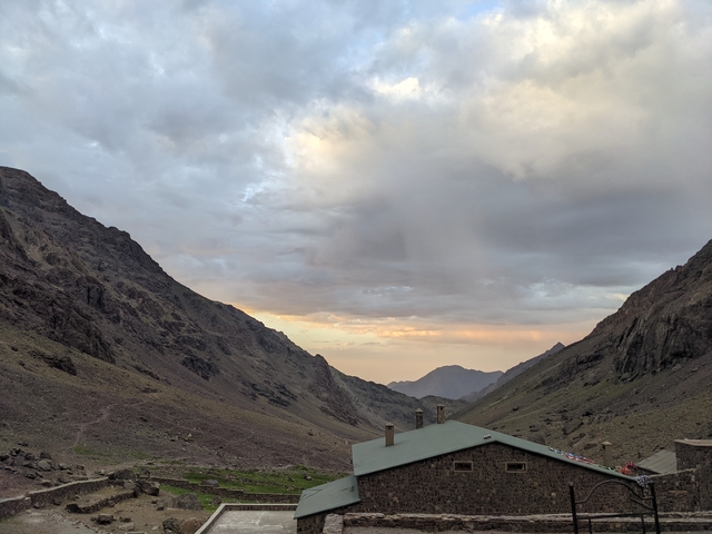 Mountain landscape view with cloudy sky at sunset.