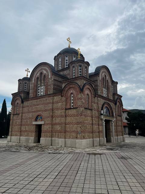      View of a large stone church with ornate details.
  