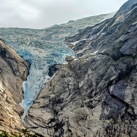 A glacier nestled within rugged mountains.