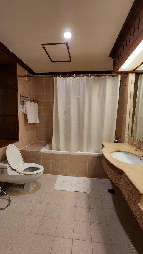       Bathroom with a bathtub, toilet, and sink.
  