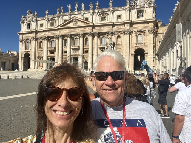       Couple posing in front of a historic building.
  