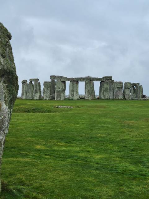       Stonehenge, ancient stone monument in a grassy field.
  