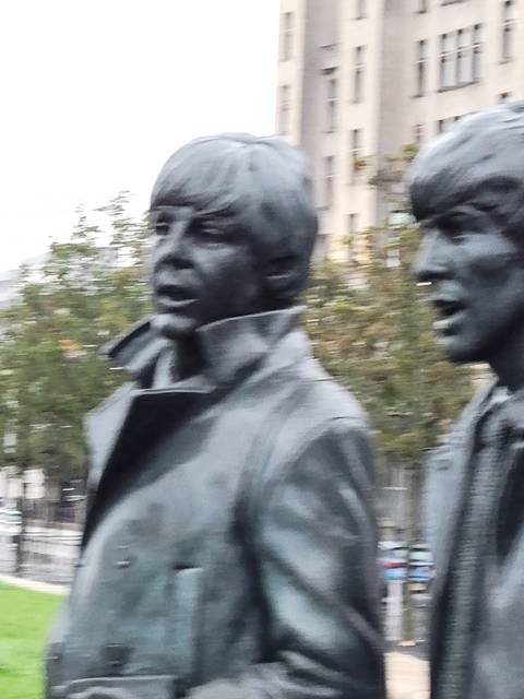       Close-up of a metal statue of a historical figure.
  