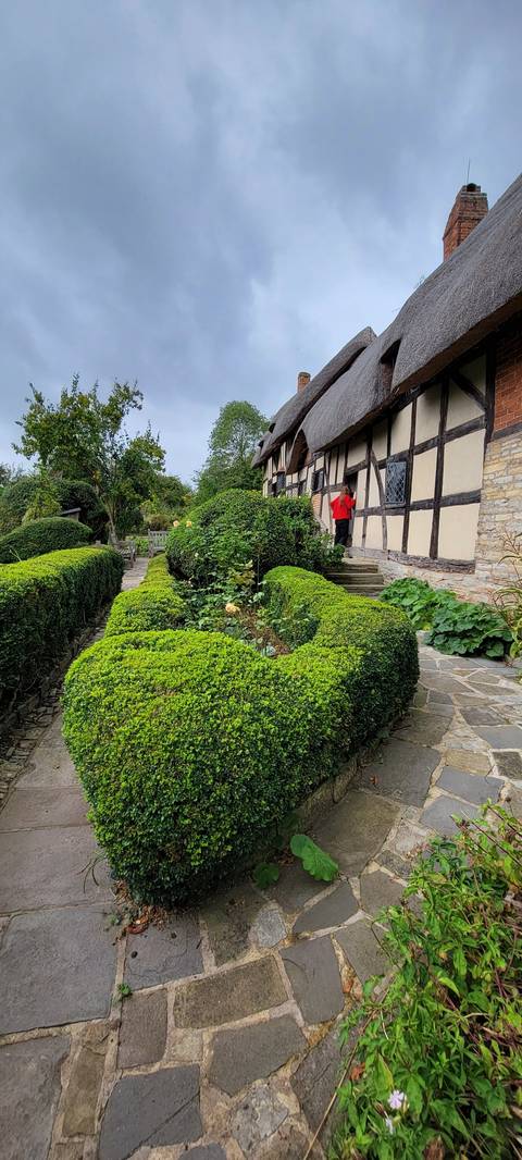      Traditional cottage with manicured gardens.
  