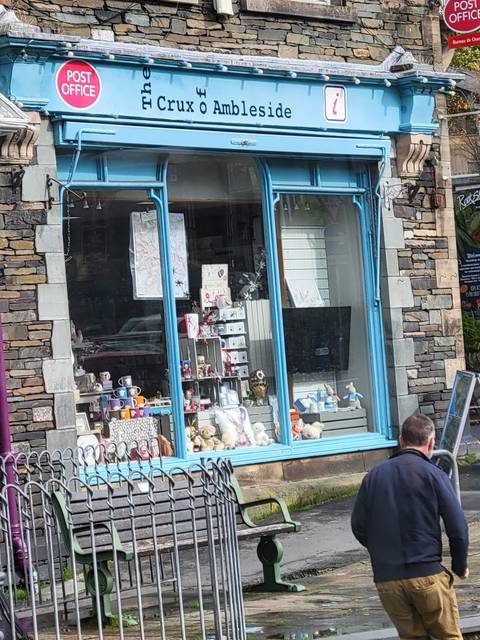       Quaint shop front with various items displayed.
  