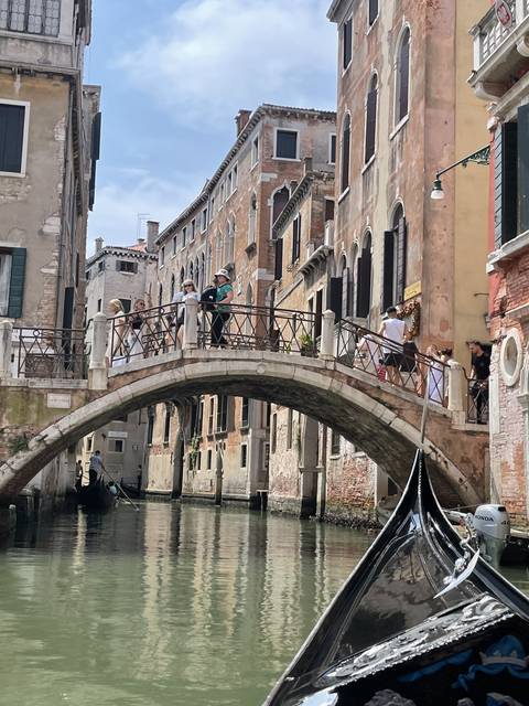 Venetian canal with gondolas and bridge.