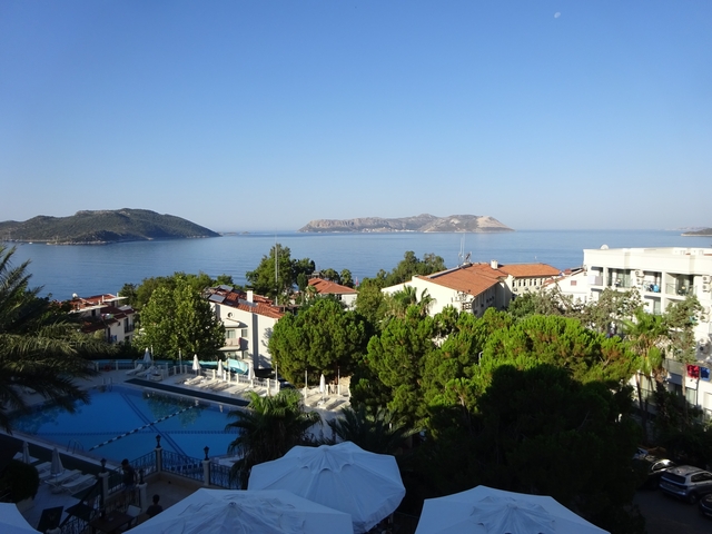       View of a coastal town with islands in the background.
  