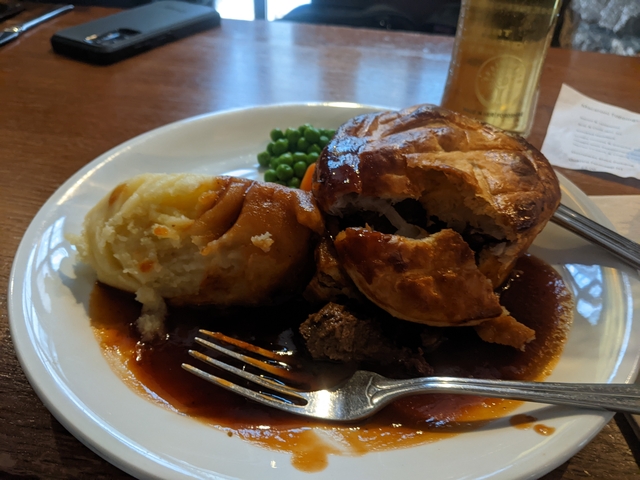 Plate of meat pie with mashed potatoes and vegetables.