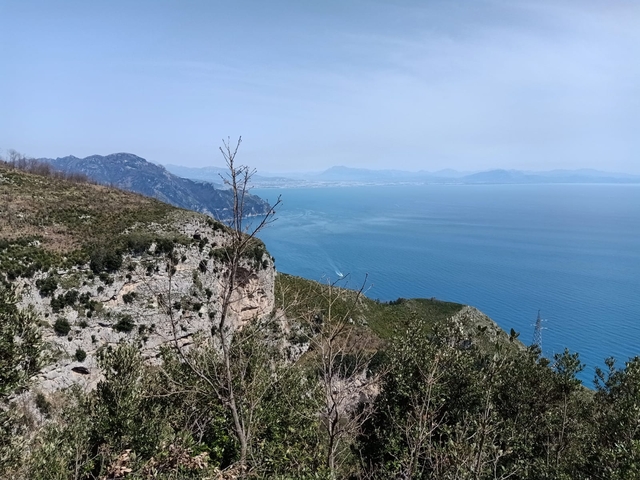 A wide view of a coastline with clear blue waters.