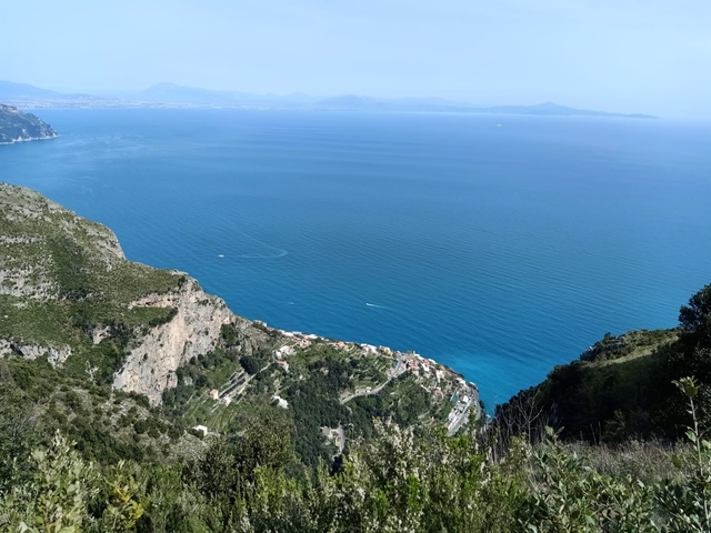 A stunning view of the coastline and blue sea from above.