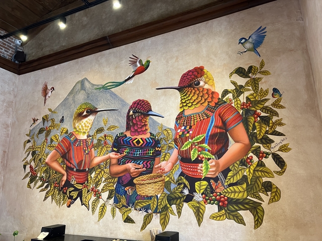       Colorful mural depicting people with birds and mountains.
  