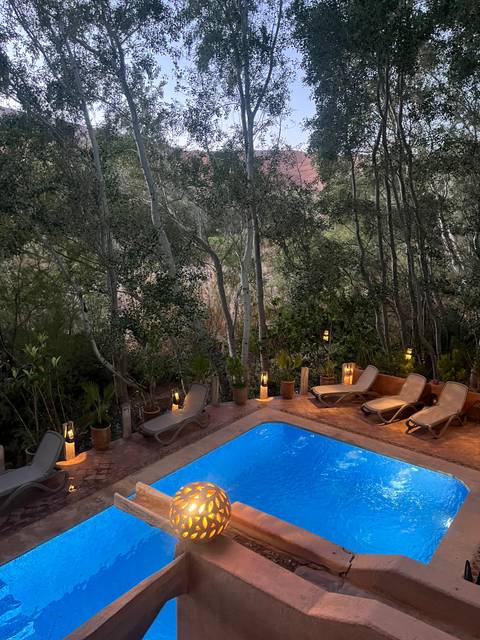 Outdoor pool area surrounded by trees.