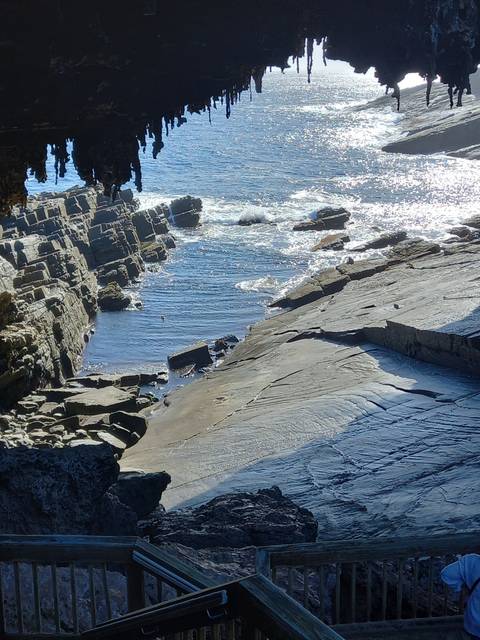 Coastline with rock formations and ocean waves.