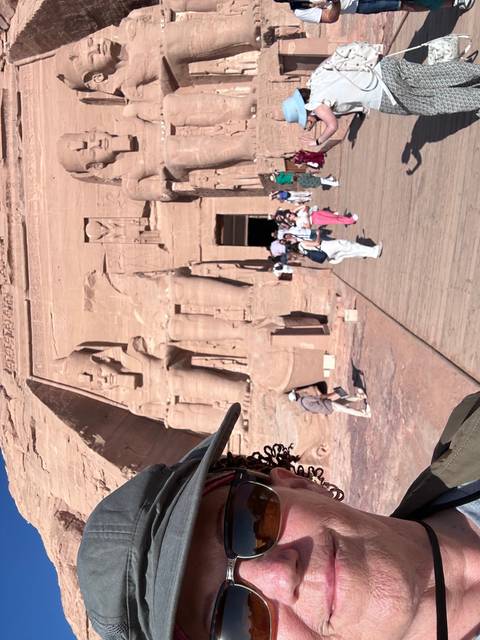       Tourist posing in front of the Abu Simbel temple.
  