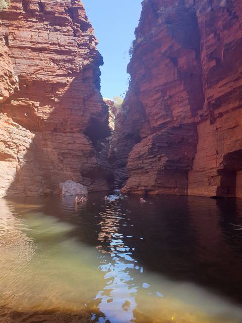       A serene rock formation with water reflecting.
  