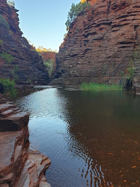 A serene canyon with a calm water body below.