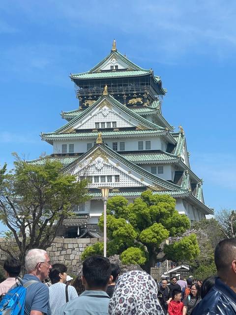A group of people visiting a traditional Japanese castle.
