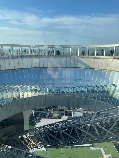A modern glass building reflecting the sky.