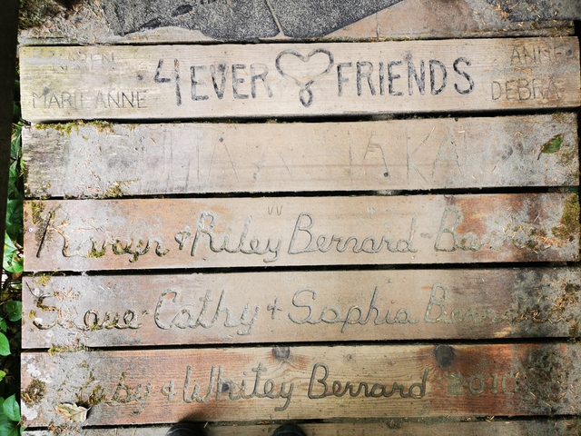 Wooden planks with engraved names.
