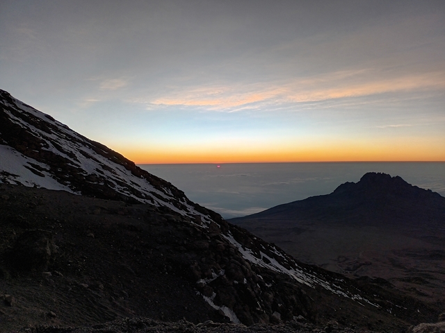       A stunning view of sunrise over a mountain landscape.
  