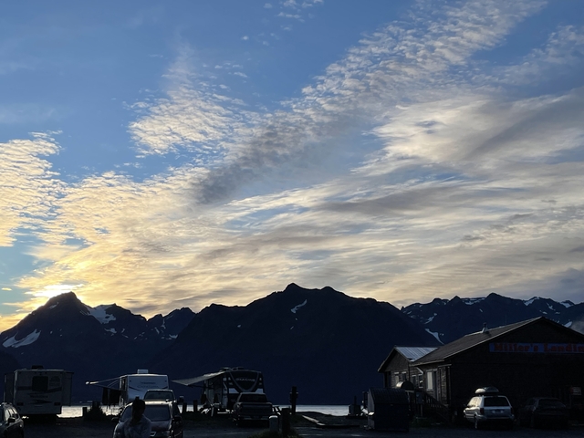       Silhouette of mountains with a cloudy sky during sunset.
  