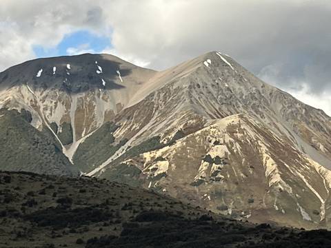       Aerial view of a mountain range with distinctive rock patterns.
  