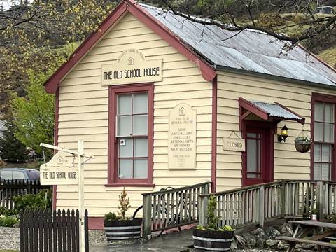       An upside-down image of a wooden building with signage.
  